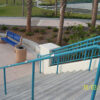 Grind To A Halt Round Handrail Minders installed on an outdoor painted handrail.